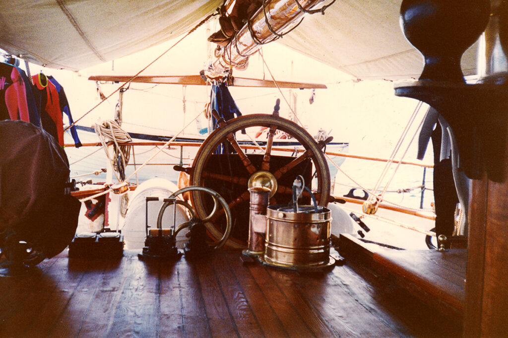 The ship's wheel at the helm of The Eye of the Wind.