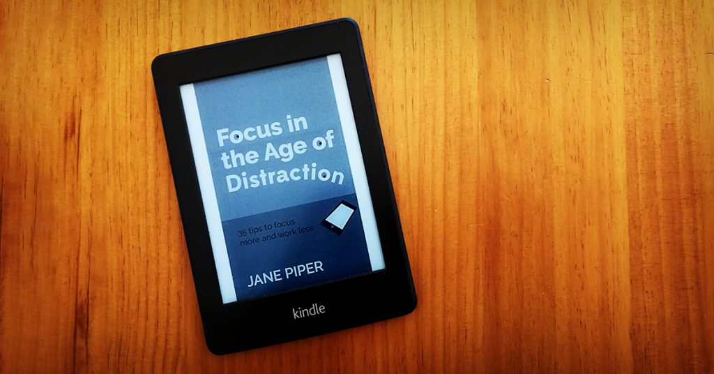 Tim Horan's kindle e-reader with the cover of 'Focus in the Age of Distraction' by Jane Piper on the display.